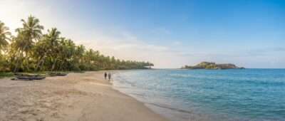 Calm turquoise sea at Nilaveli beach near Trincomalee, Sri Lanka in August, with Pigeon Island on the horizon