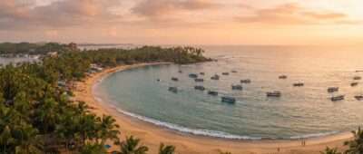 Palm-fringed Mirissa bay with whale-watching boats on a calm January sea, Sri Lanka