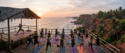 Sunrise yoga class on a cliff-top shala above the Arabian Sea at Varkala, one of the best yoga retreats in Kerala